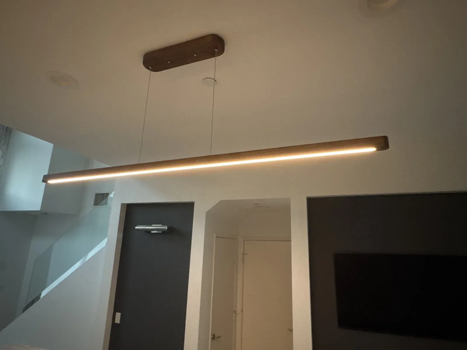 Linear wood LED pendant light installed by TruLuxe Electric