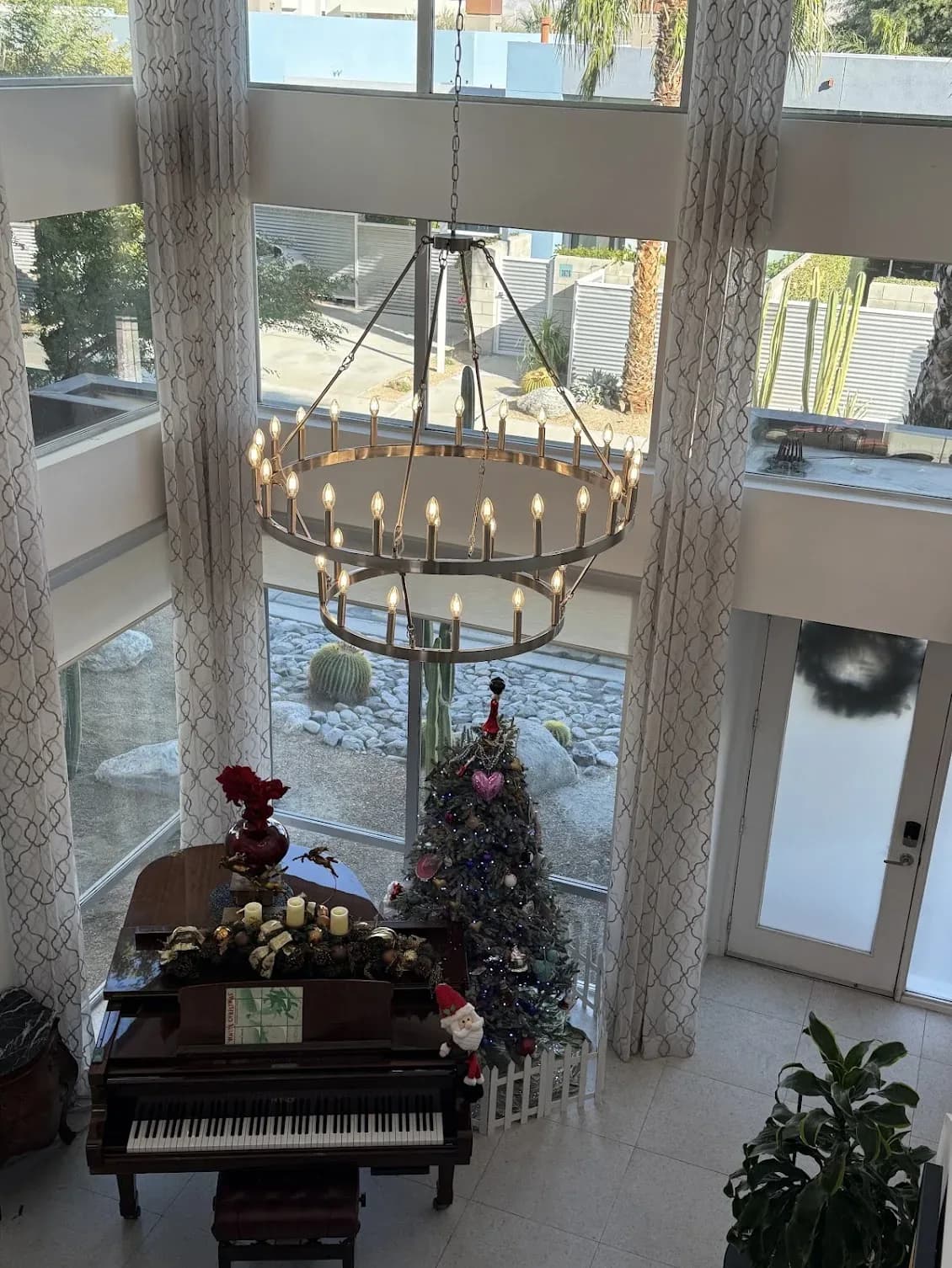 Two-tier candelabra chandelier installed by TruLuxe Electric in a high-ceiling living room