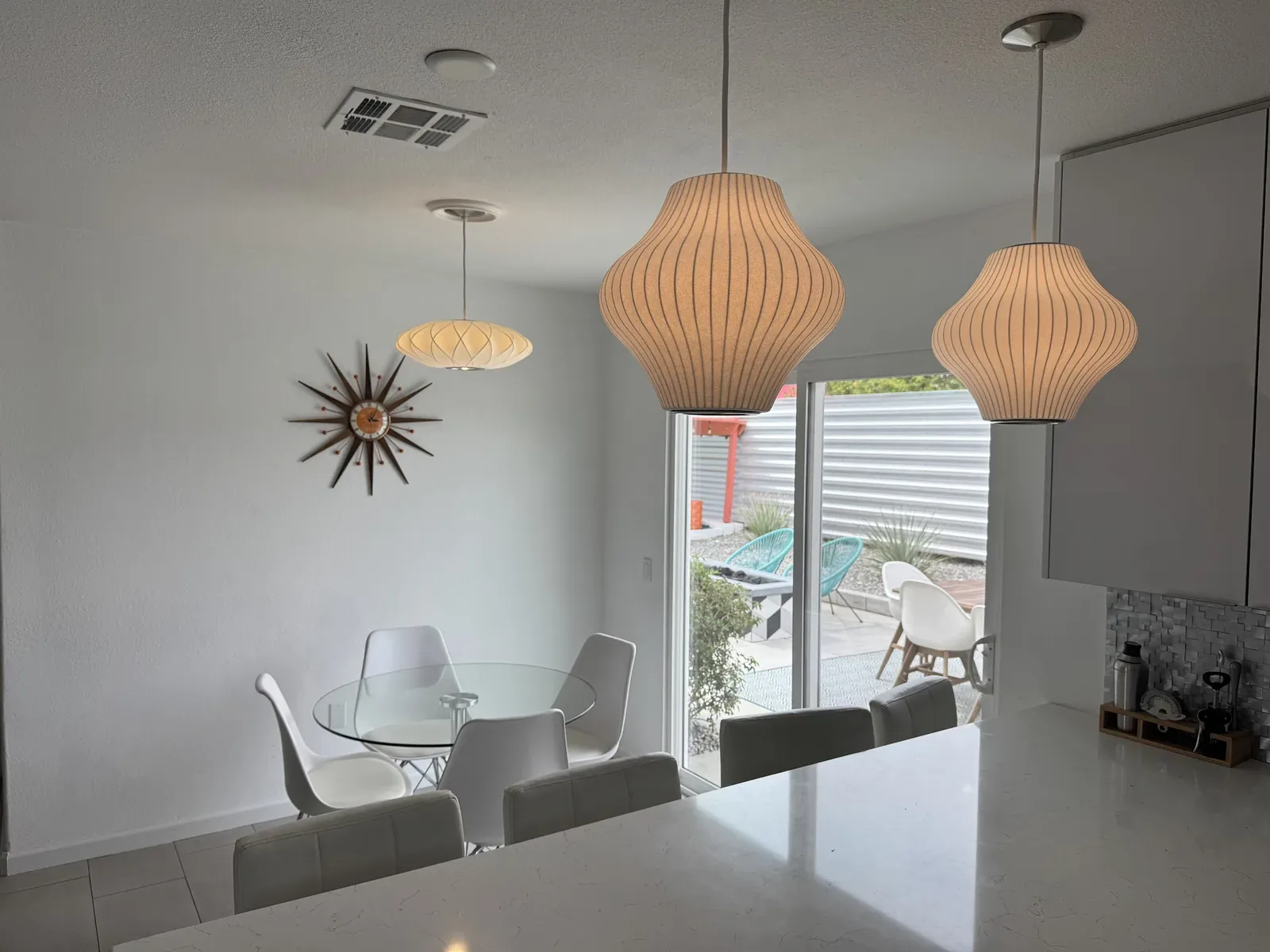 Mid-century pendant lights installed by TruLuxe Electric over a dining area