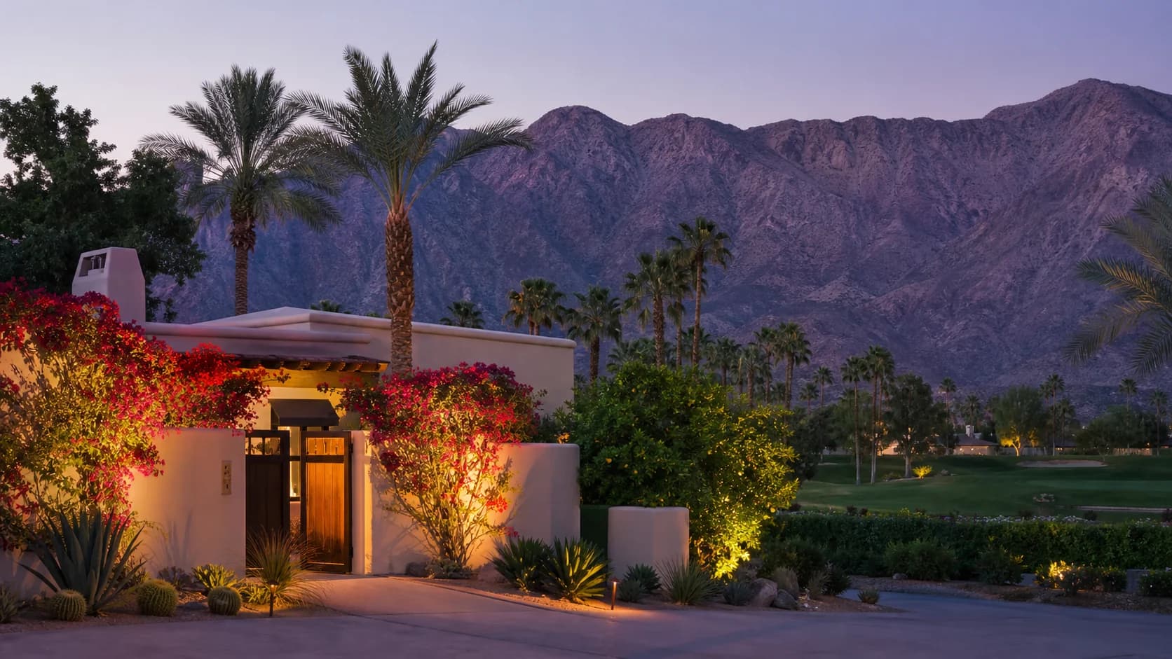 Indian Wells country-club home with bougainvillea, palms, golf landscape, and close mountains